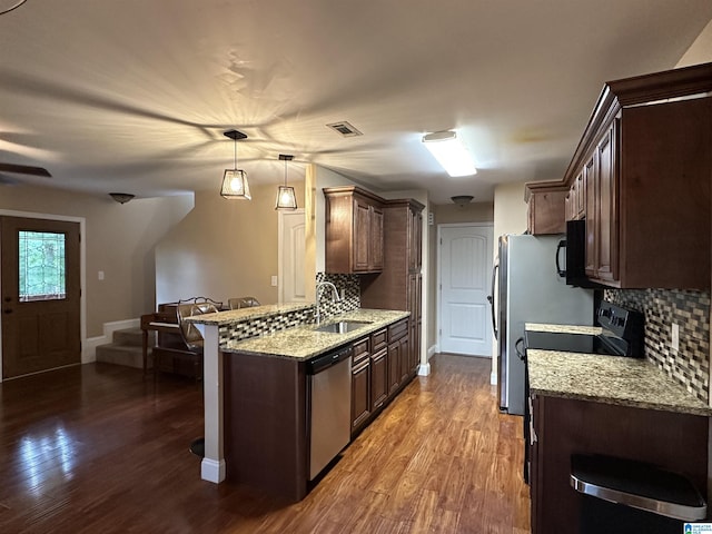 21131 Delmar Dr, Lake View, AL 35111 - kitchen with dishwasher, backsplash, dark wood finished floors, and dark brown cabinetry