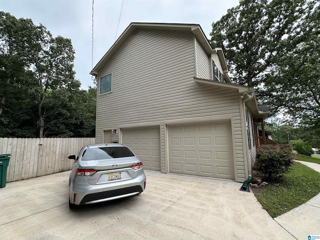 21131 Delmar Dr, Lake View, AL 35111 - view of side of property with concrete driveway and an attached garage