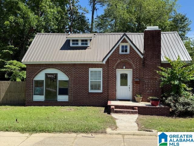 1005 4th Ave N, Clanton, AL 35045 - view of front of home with a chimney, brick siding, and metal roof