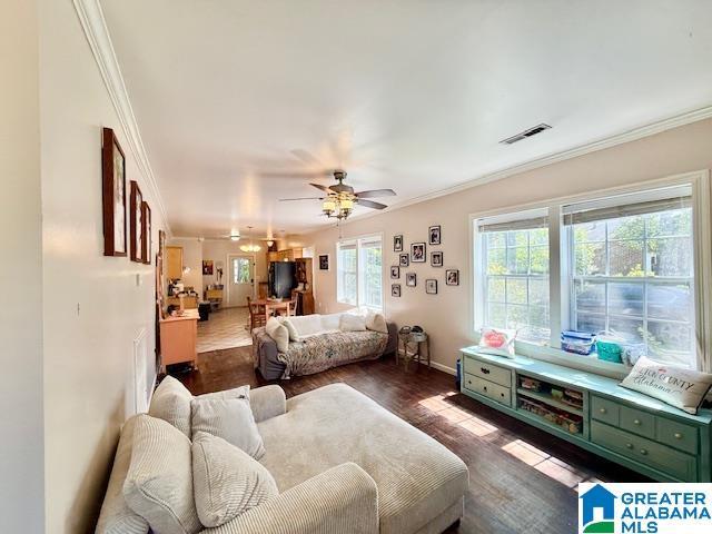 1005 4th Ave N, Clanton, AL 35045 - bedroom with crown molding, dark wood finished floors, fridge, baseboards, and a ceiling fan