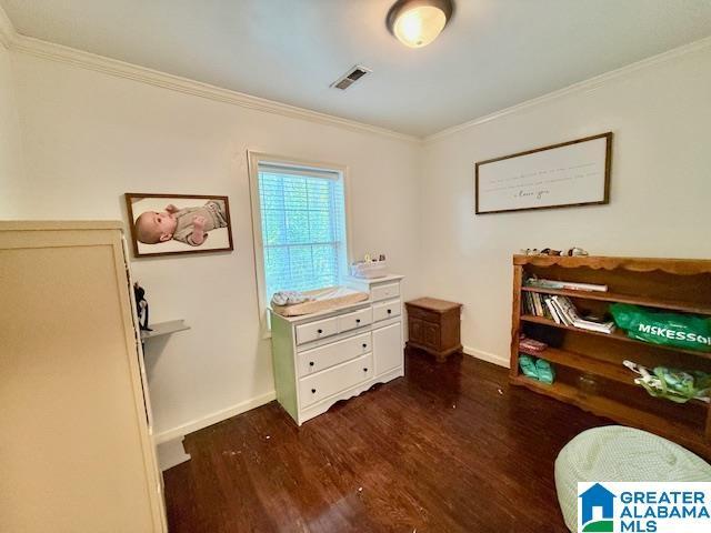 1005 4th Ave N, Clanton, AL 35045 - office space with crown molding, dark wood-type flooring, and baseboards