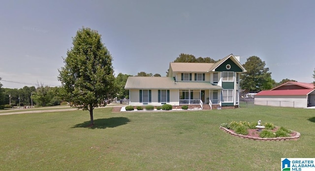 1709 Round Hill Rd, Weaver, AL 36277 - view of front of property with a porch, a front lawn, and metal roof