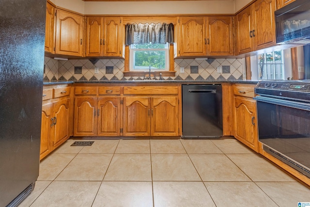 1709 Round Hill Rd, Weaver, AL 36277 - kitchen with black appliances, dark countertops, brown cabinets, and a sink