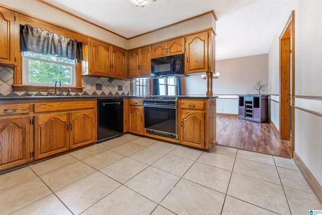1709 Round Hill Rd, Weaver, AL 36277 - kitchen featuring black appliances, dark countertops, brown cabinets, and crown molding