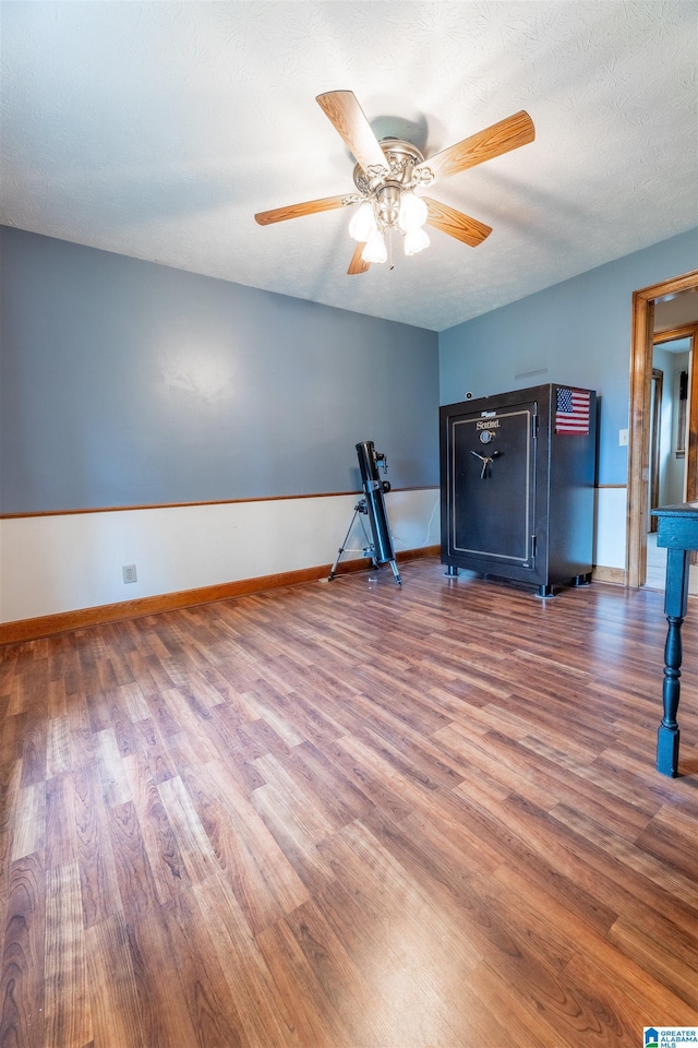 1709 Round Hill Rd, Weaver, AL 36277 - workout room with wood finished floors, a ceiling fan, and baseboards