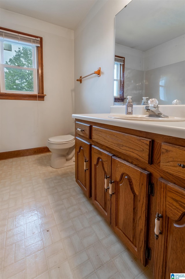 1709 Round Hill Rd, Weaver, AL 36277 - bathroom featuring vanity, tile patterned floors, toilet, and baseboards