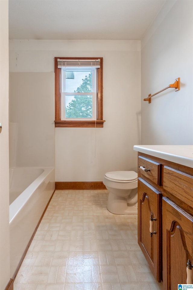 1709 Round Hill Rd, Weaver, AL 36277 - bathroom featuring tile patterned floors, vanity, toilet, a bathtub, and baseboards