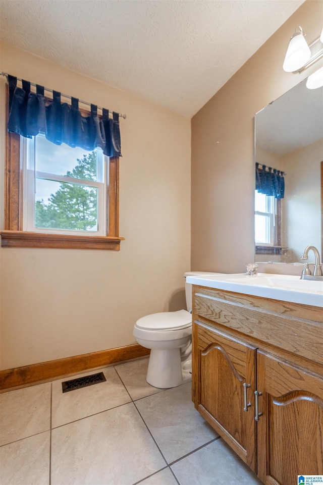 1709 Round Hill Rd, Weaver, AL 36277 - bathroom with tile patterned flooring, vanity, toilet, and baseboards