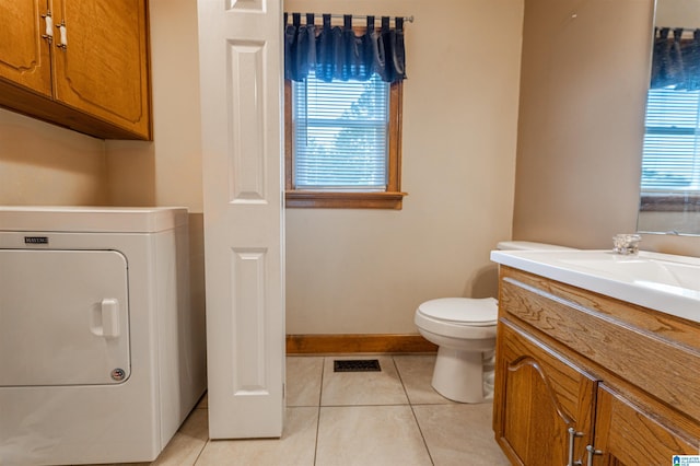 1709 Round Hill Rd, Weaver, AL 36277 - bathroom featuring washer / dryer, tile patterned floors, toilet, vanity, and healthy amount of natural light