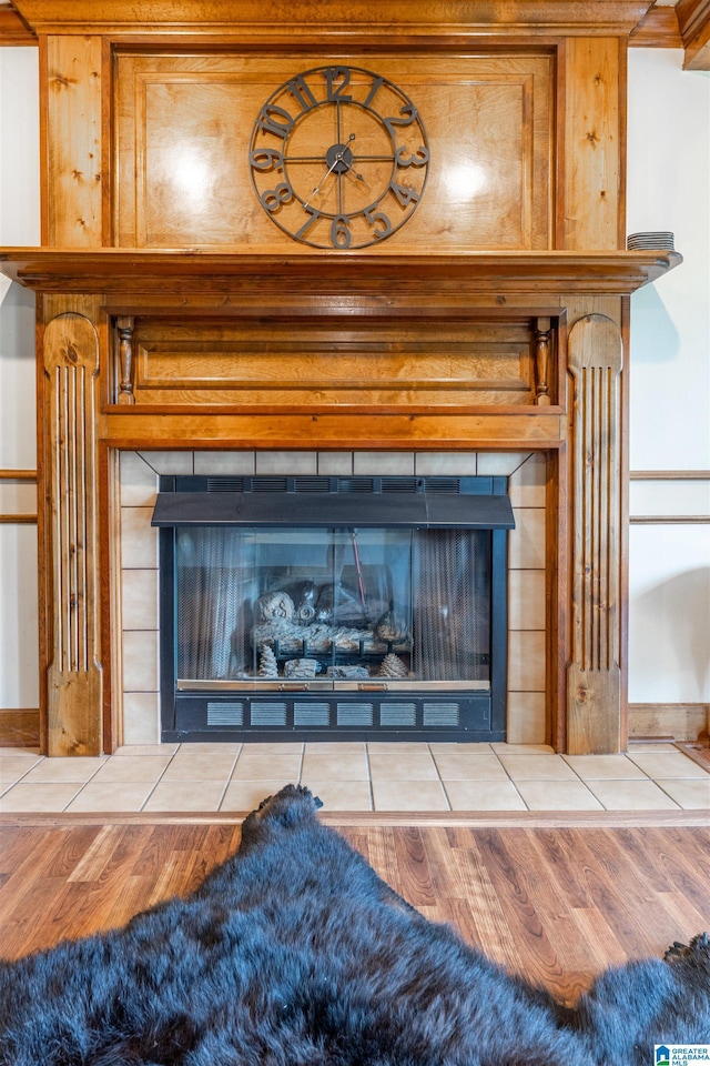 1709 Round Hill Rd, Weaver, AL 36277 - detailed view of a tile fireplace, wood finished floors, and baseboards