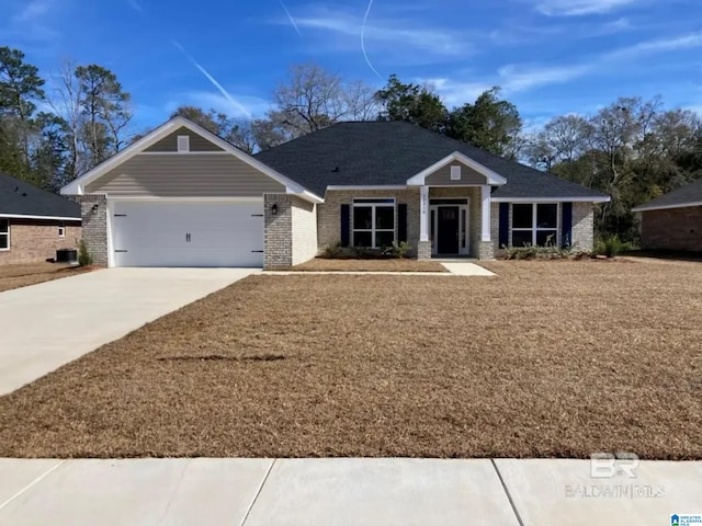 744 Jamestown Cir, Montevallo, AL 35115 - view of front of home featuring brick siding, a garage, and concrete driveway