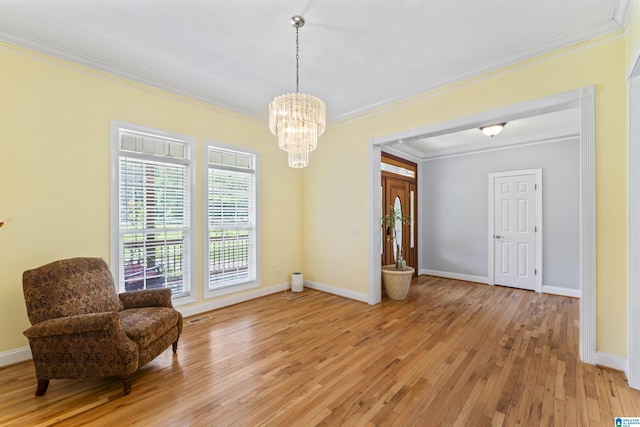 691 Reid Dr, Trafford, AL 35172 - living area featuring ornamental molding, a chandelier, light wood-style flooring, and baseboards
