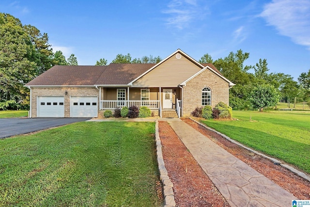 159 Williams Rd, Cullman, AL 35057 - ranch-style home with brick siding, covered porch, asphalt driveway, a garage, and a front yard