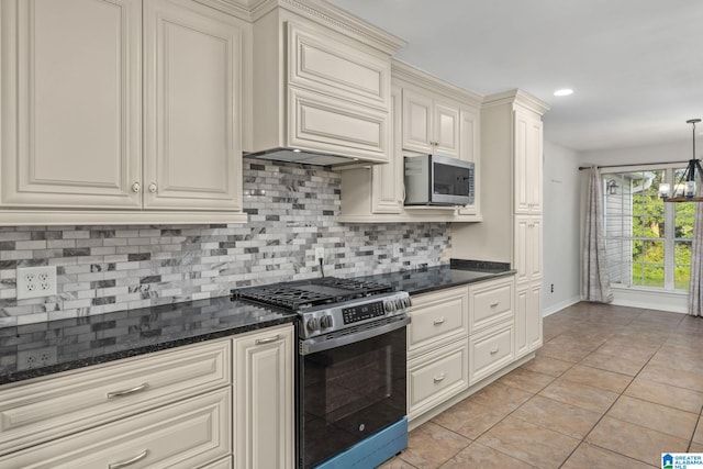 159 Williams Rd, Cullman, AL 35057 - kitchen featuring appliances with stainless steel finishes, cream cabinets, tasteful backsplash, baseboards, and premium range hood