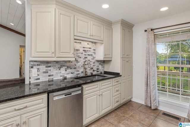159 Williams Rd, Cullman, AL 35057 - kitchen featuring stainless steel dishwasher, a sink, decorative backsplash, dark stone counters, and baseboards