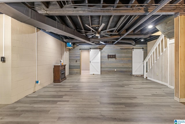 159 Williams Rd, Cullman, AL 35057 - finished basement with a barn door, wood finished floors, stairway, and wooden walls