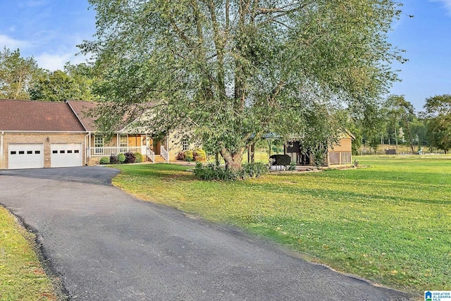 159 Williams Rd, Cullman, AL 35057 - view of front of house featuring an attached garage, driveway, a front yard, and covered porch