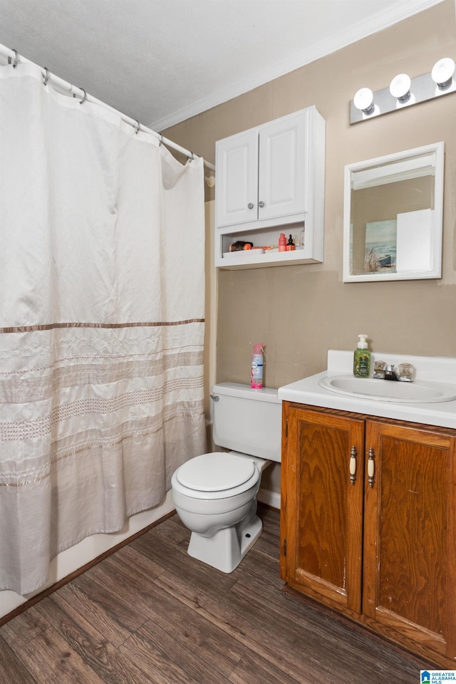 4507 Charles Ave, Anniston, AL 36206 - full bathroom with wood finished floors, toilet, vanity, and crown molding