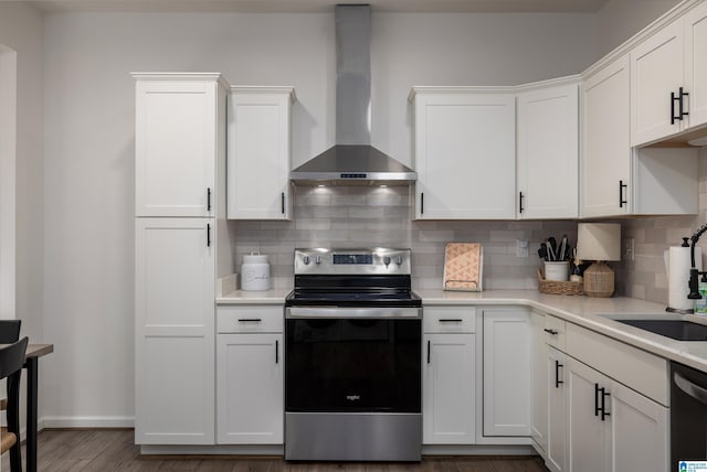 5883 William O Ln, Gardendale, AL 35071 - kitchen featuring appliances with stainless steel finishes, wall chimney exhaust hood, a sink, tasteful backsplash, and white cabinets
