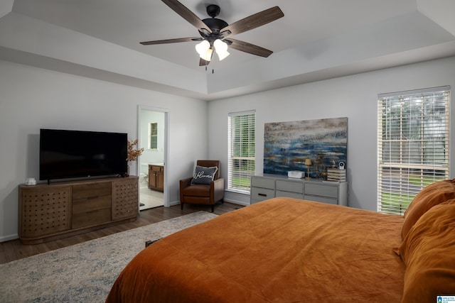 5883 William O Ln, Gardendale, AL 35071 - bedroom featuring wood finished floors, a tray ceiling, ensuite bathroom, and a ceiling fan