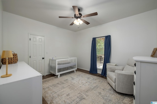 5883 William O Ln, Gardendale, AL 35071 - bedroom with a crib, wood finished floors, and ceiling fan