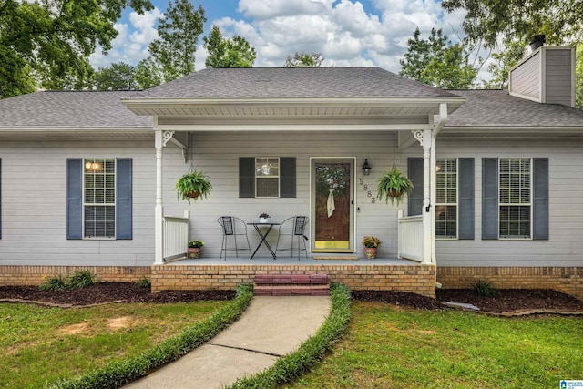 5883 William O Ln, Gardendale, AL 35071 - view of front of property with covered porch, a chimney, a shingled roof, a front yard, and crawl space