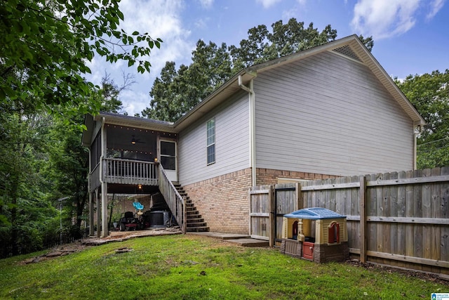 5883 William O Ln, Gardendale, AL 35071 - back of property featuring ceiling fan, a sunroom, brick siding, cooling unit, and stairs