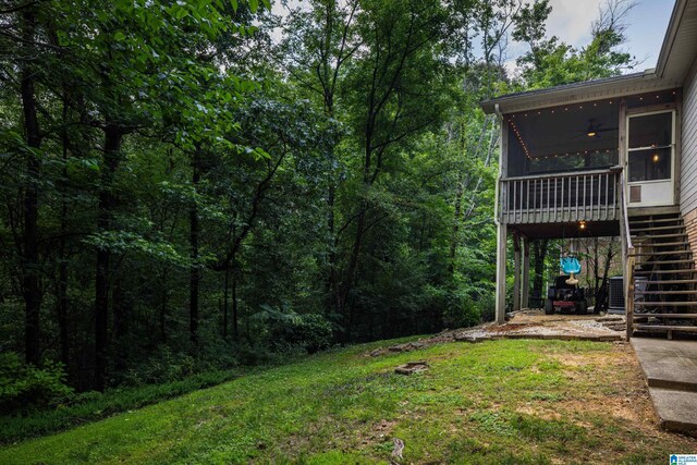 5883 William O Ln, Gardendale, AL 35071 - view of grassy yard featuring stairs, a sunroom, and a forest view