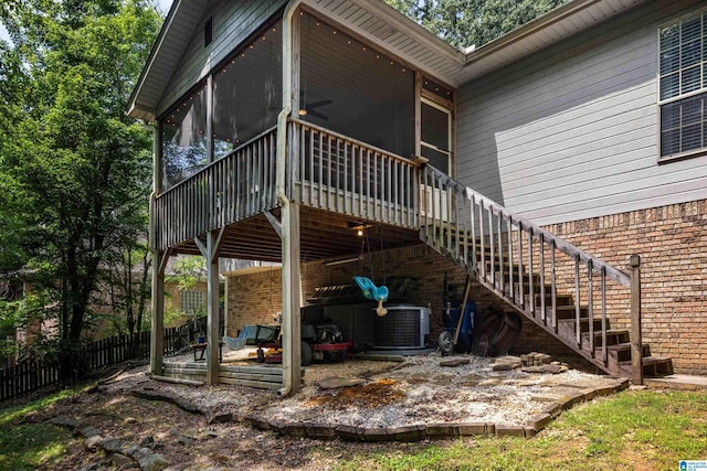 5883 William O Ln, Gardendale, AL 35071 - back of house with a sunroom, stairs, central air condition unit, brick siding, and a wooden deck
