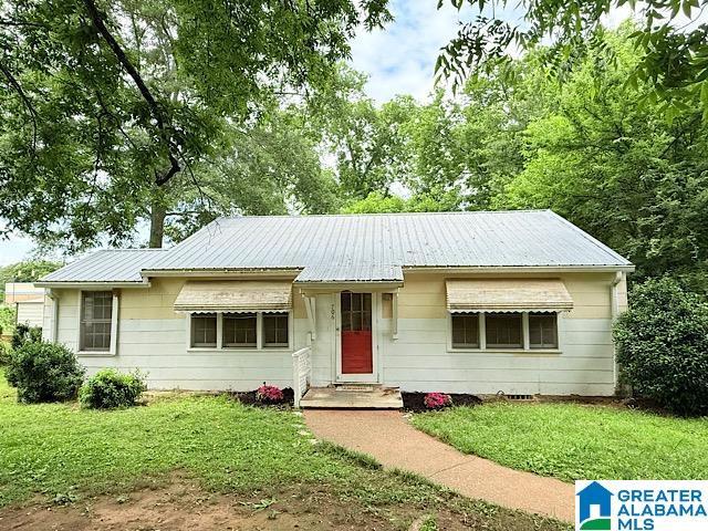 706 Coffee St E, Talladega, AL 35160 - view of front of home featuring a front yard and metal roof
