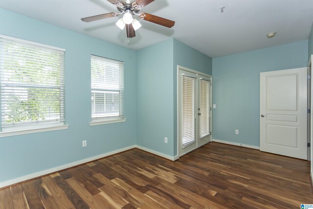 401 20th St S Unit 322, Birmingham, AL 35233 - unfurnished bedroom featuring dark wood-style flooring, baseboards, and a ceiling fan