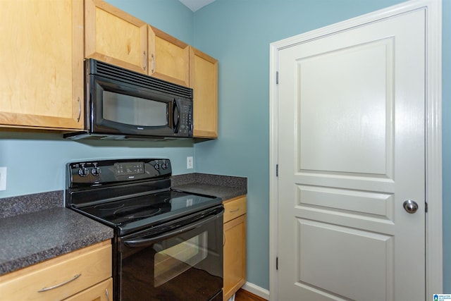 401 20th St S Unit 322, Birmingham, AL 35233 - kitchen with black appliances, light brown cabinetry, and dark countertops