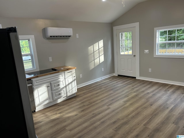 140 County Road 603, Hanceville, AL 35077 - unfurnished living room with a wall mounted air conditioner, plenty of natural light, wood finished floors, lofted ceiling, and baseboards