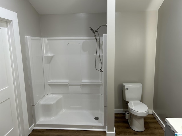 140 County Road 603, Hanceville, AL 35077 - full bath with wood finished floors, a shower, toilet, vanity, and baseboards