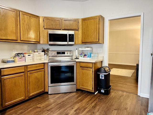 2004 Waterford Pl Unit 2004, Hoover, AL 35244 - kitchen featuring stainless steel appliances, light countertops, dark wood finished floors, and brown cabinets