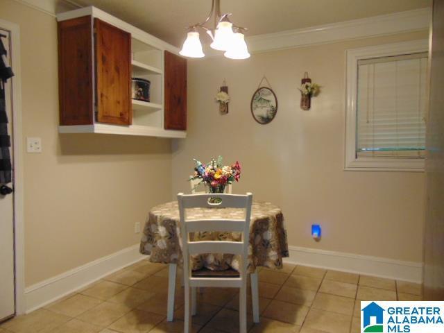 101 Randall Cir, Clanton, AL 35045 - dining area with a chandelier, light tile patterned flooring, and ornamental molding