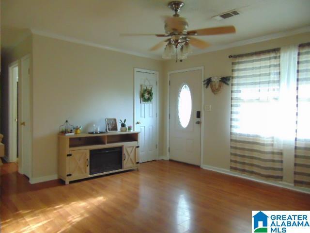 101 Randall Cir, Clanton, AL 35045 - foyer with a ceiling fan, crown molding, and light wood-type flooring