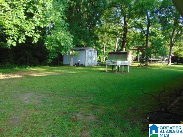 101 Randall Cir, Clanton, AL 35045 - view of green lawn with a storage shed