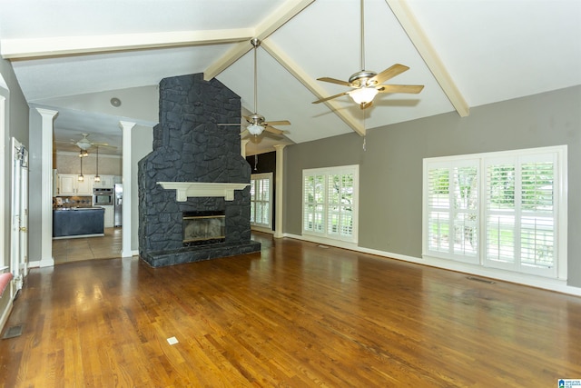2940 Coatbridge Ln, Birmingham, AL 35242 - unfurnished living room with ceiling fan, a fireplace, beamed ceiling, wood finished floors, and decorative columns