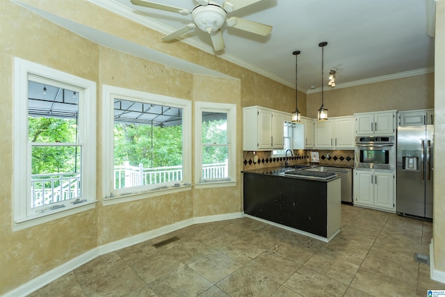 2940 Coatbridge Ln, Birmingham, AL 35242 - kitchen featuring stainless steel appliances, dark countertops, white cabinets, decorative backsplash, and a peninsula