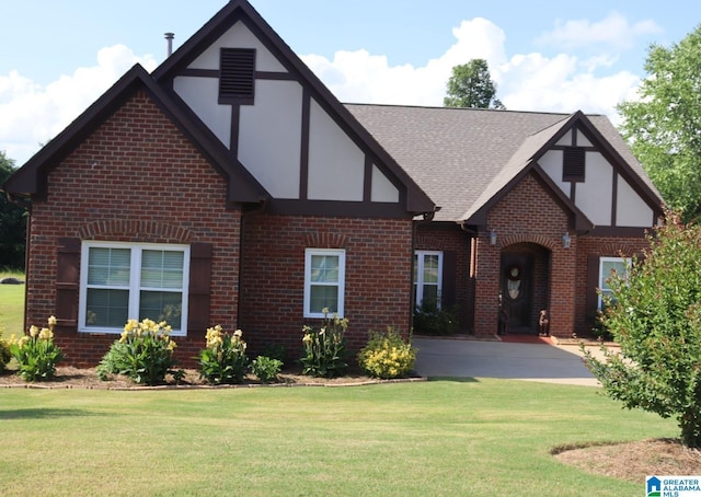 1035 Princeton Park, Montevallo, AL 35115 - tudor-style house featuring brick siding, a front yard, and roof with shingles