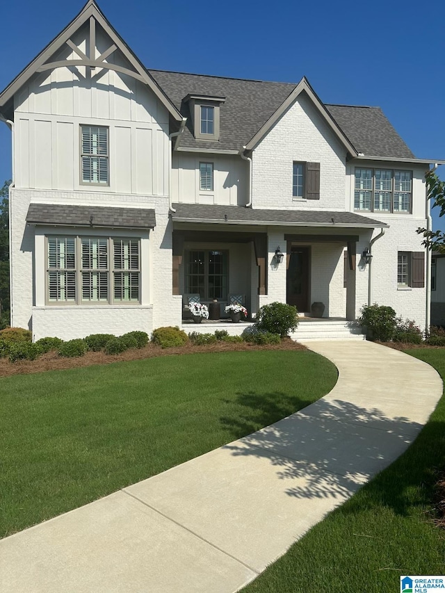 1924 Blackridge Rd, Hoover, AL 35244 - view of front facade featuring board and batten siding, a front yard, and a shingled roof