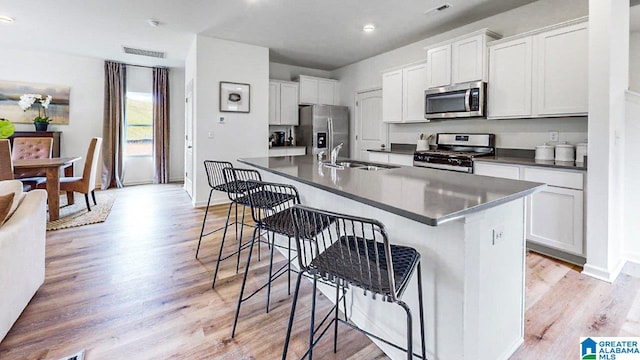 2300 Surry Dr SW, Cullman, AL 35055 - kitchen with appliances with stainless steel finishes, a sink, dark countertops, light wood-type flooring, and recessed lighting