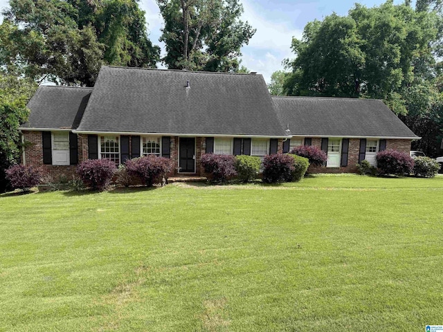 3593 Springhill Rd, Mountain Brook, AL 35223 - cape cod house with brick siding, a front yard, and roof with shingles