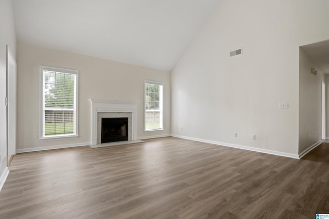 132 Summerchase Pkwy, Calera, AL 35040 - unfurnished living room with high vaulted ceiling, healthy amount of natural light, wood finished floors, and a high end fireplace