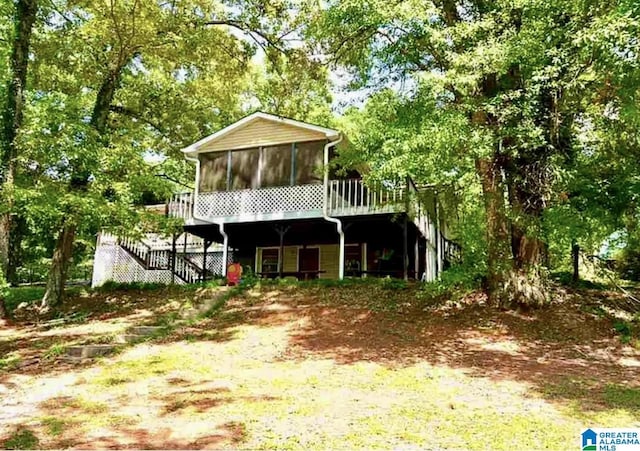 145 Maine Dr, Cropwell, AL 35054 - view of front facade featuring a sunroom, stairs, and view of scattered trees