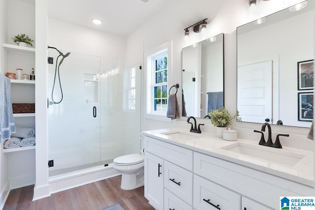 157 Shiloh Creek Dr, Calera, AL 35040 - full bath featuring a shower stall, double vanity, toilet, and wood finished floors