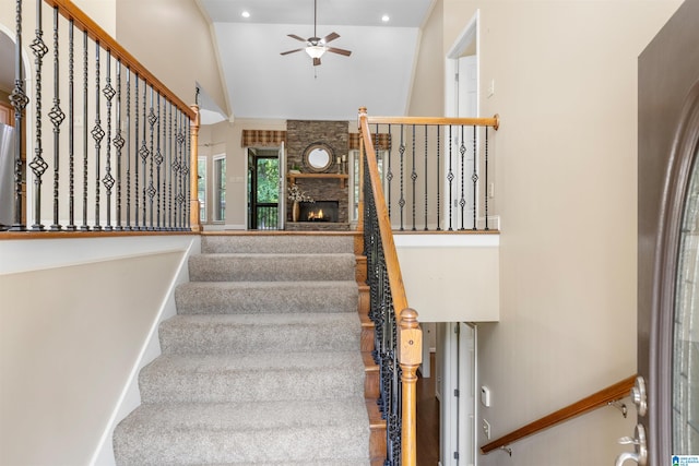 22582 Iron Masters Loop, Mccalla, AL 35111 - stairway featuring ceiling fan, recessed lighting, high vaulted ceiling, and a large fireplace