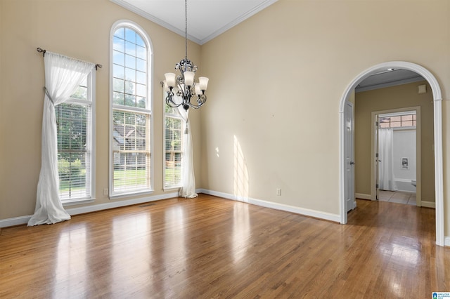 22582 Iron Masters Loop, Mccalla, AL 35111 - unfurnished dining area featuring arched walkways, crown molding, wood finished floors, a chandelier, and baseboards