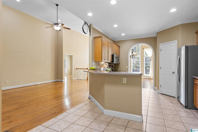 22582 Iron Masters Loop, Mccalla, AL 35111 - kitchen with stainless steel appliances, ornamental molding, a ceiling fan, light tile patterned flooring, and a peninsula